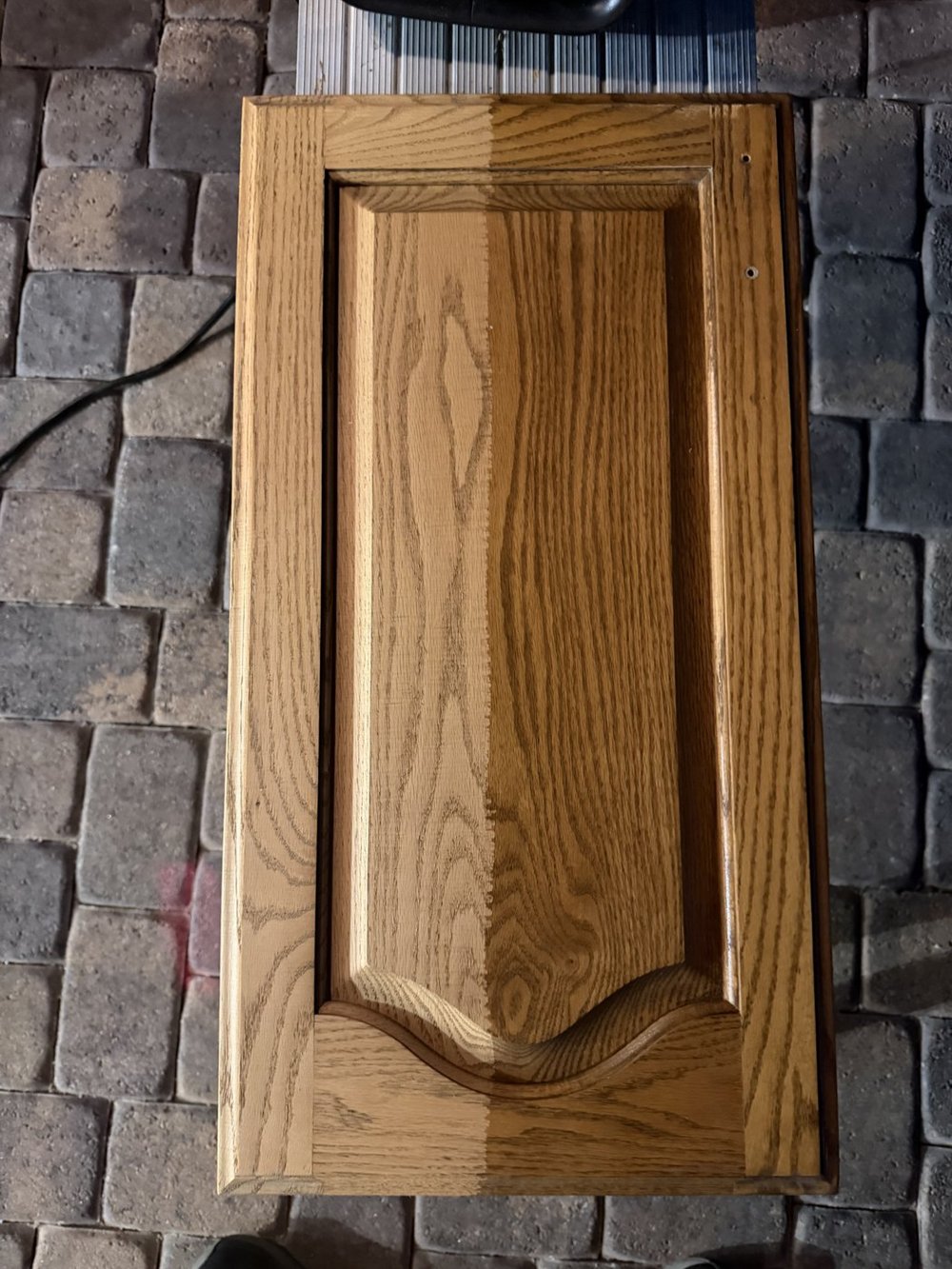 Wooden cabinet door with its finish removed by laser cleaning