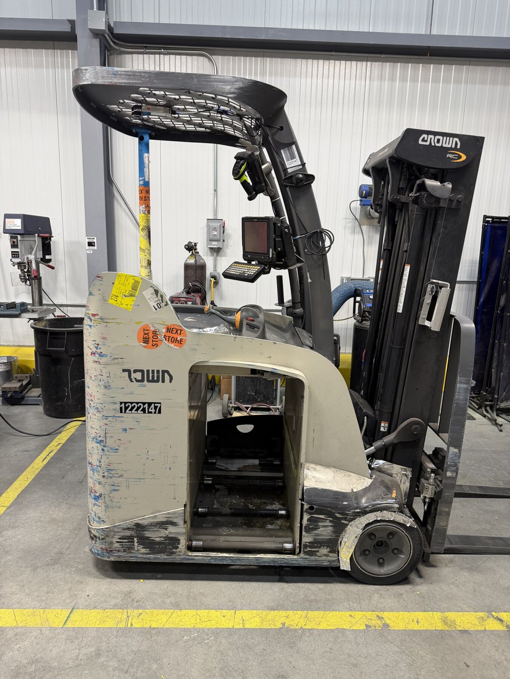 Forklift before laser cleaning, with old paint and surface buildup on the body panel